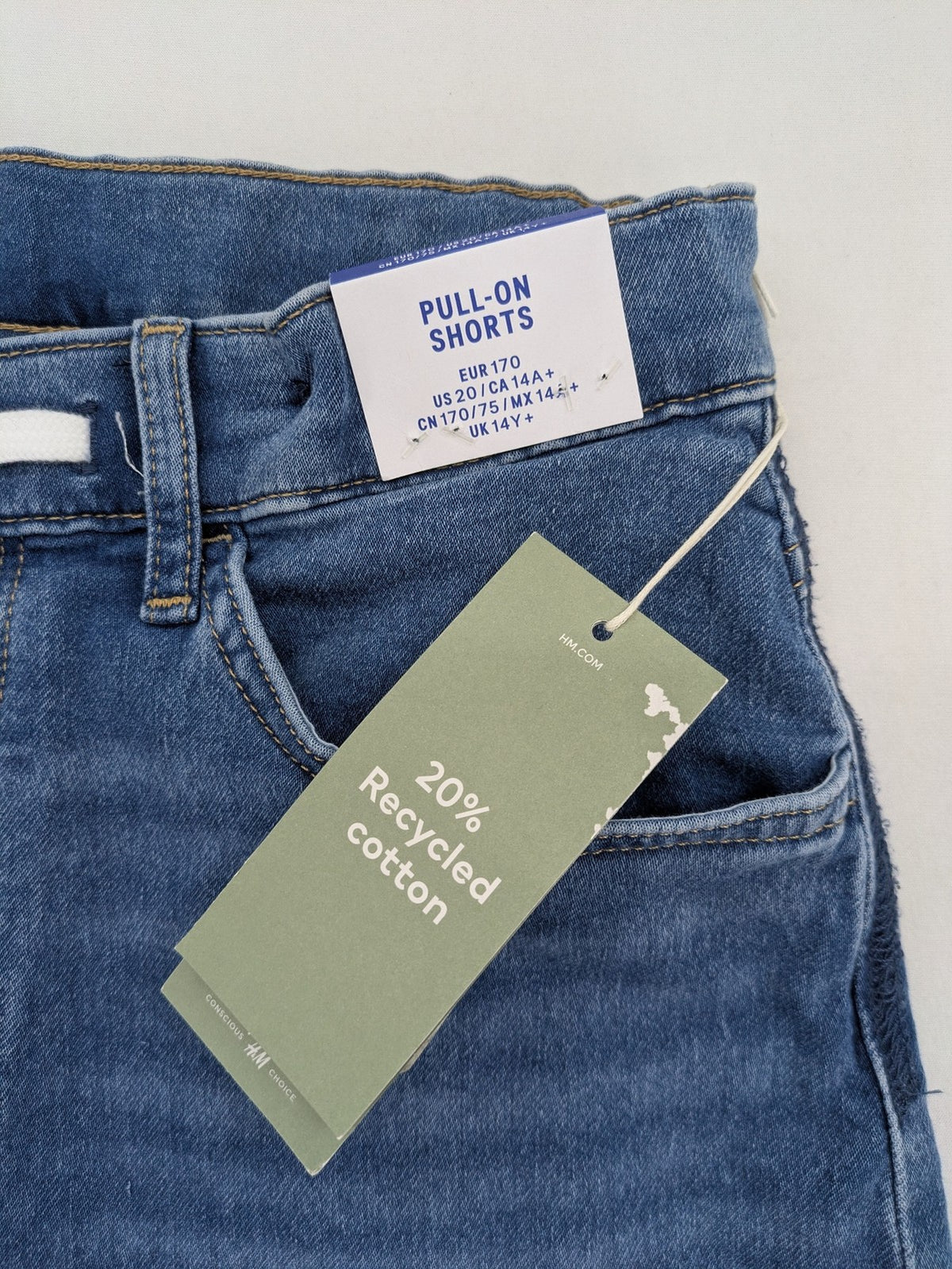 H&M blue denim shorts with adjustable drawstring, rolled hem, classic 5-pocket design.