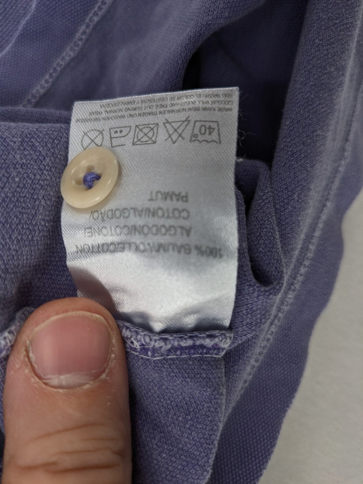 Marc O'Polo purple polo shirt garment dyed cotton with embroidered logo and intricate details.