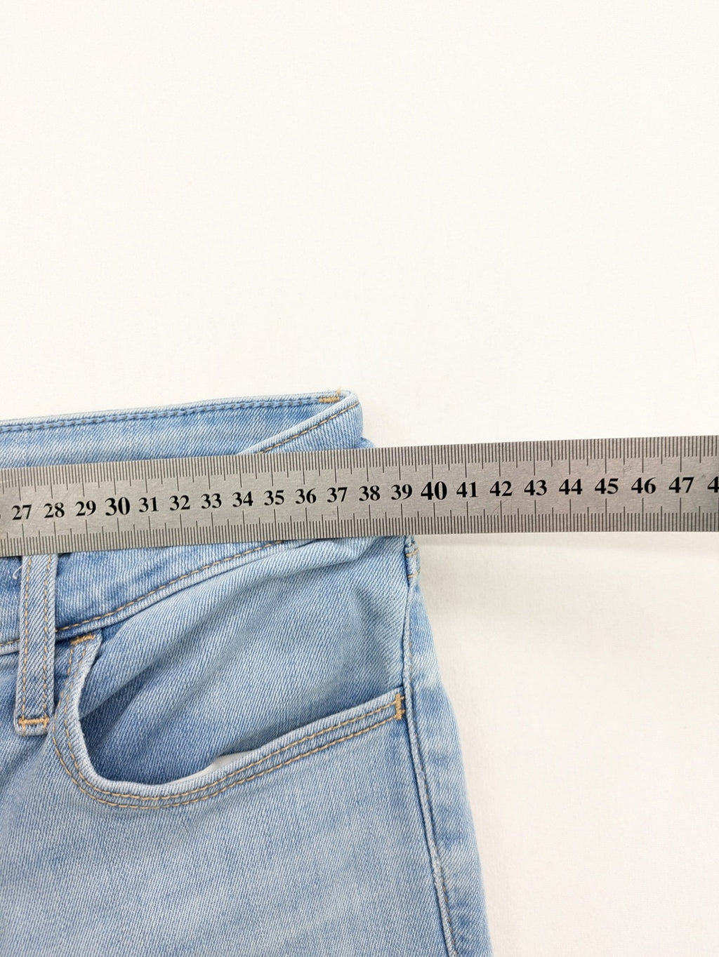 Hollister blue high-rise crop super skinny jeans with distressed rips and frayed hem.