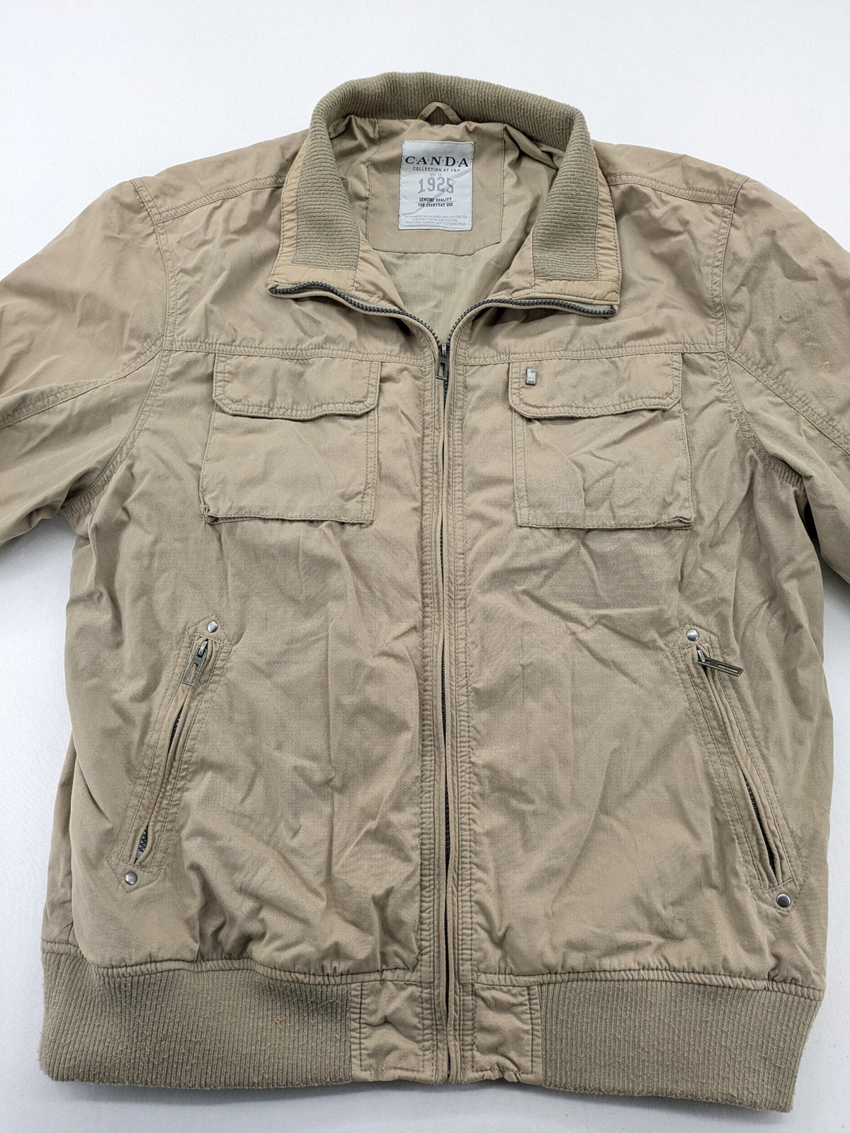 Canda beige bomber jacket full zip with ribbed collar and buttoned chest pockets.