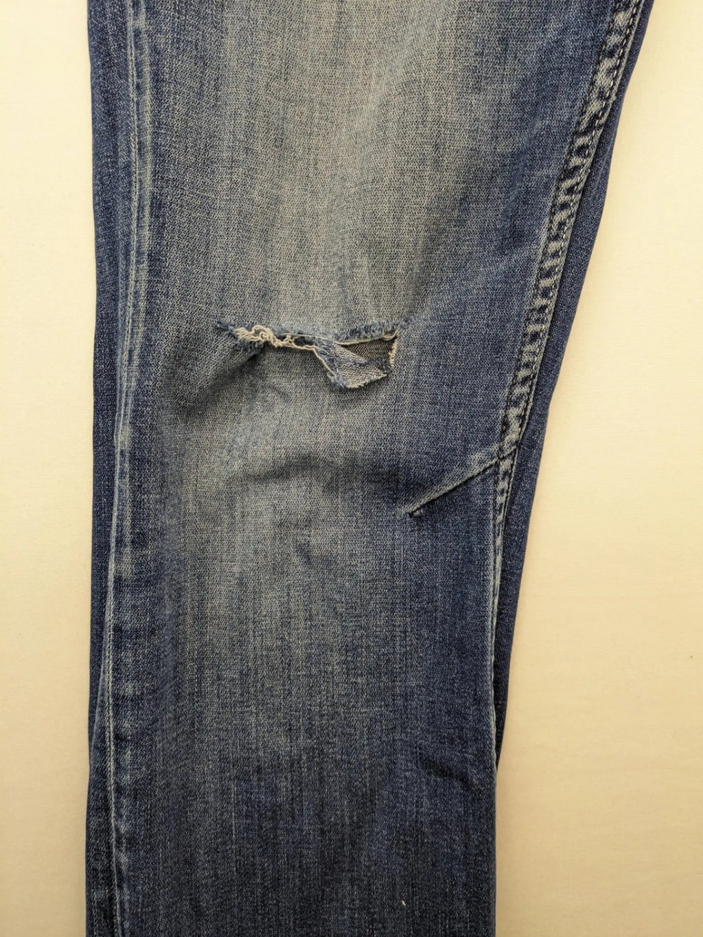 WAM Denim blue straight jeans with distressed details and button fly.