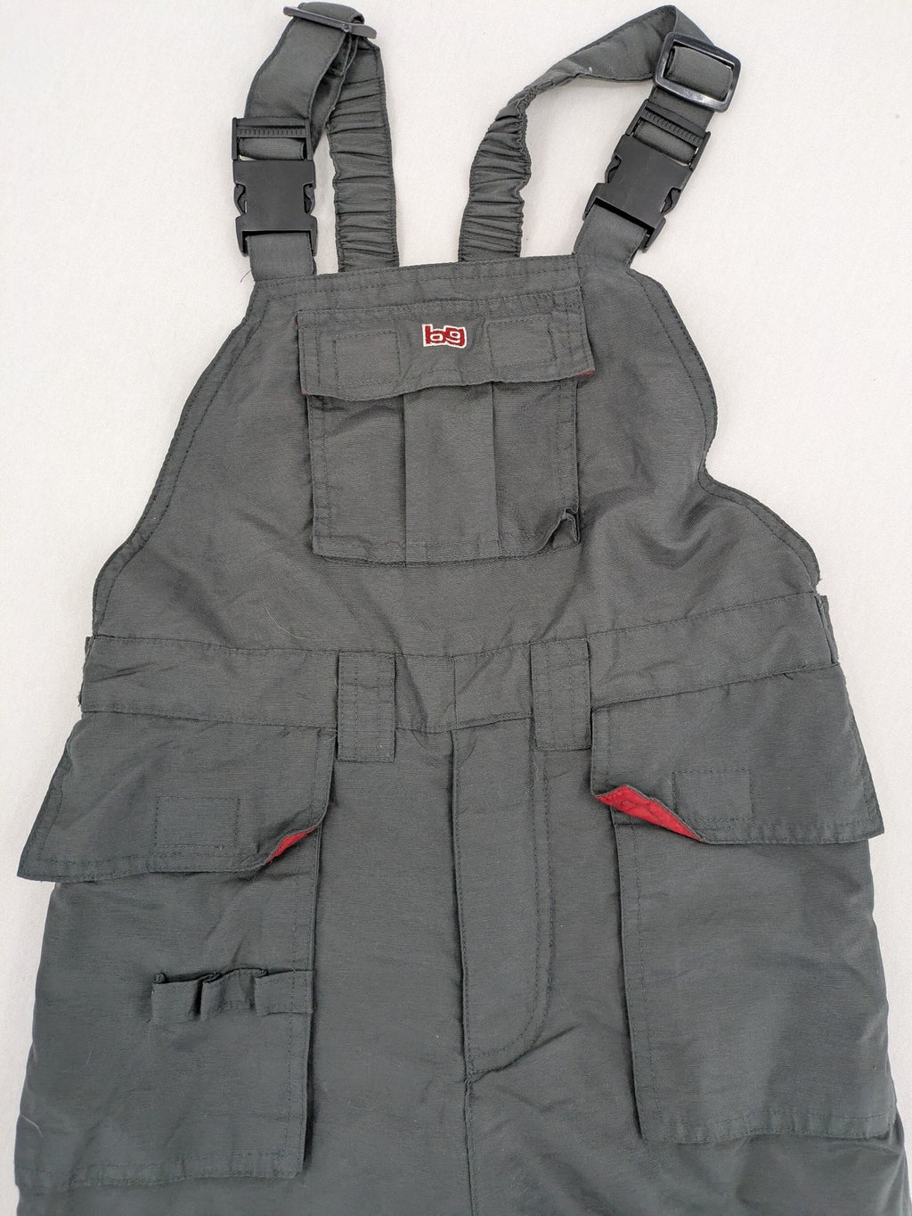 H&M grey snow pants with red accents, adjustable straps, and multiple cargo pockets.