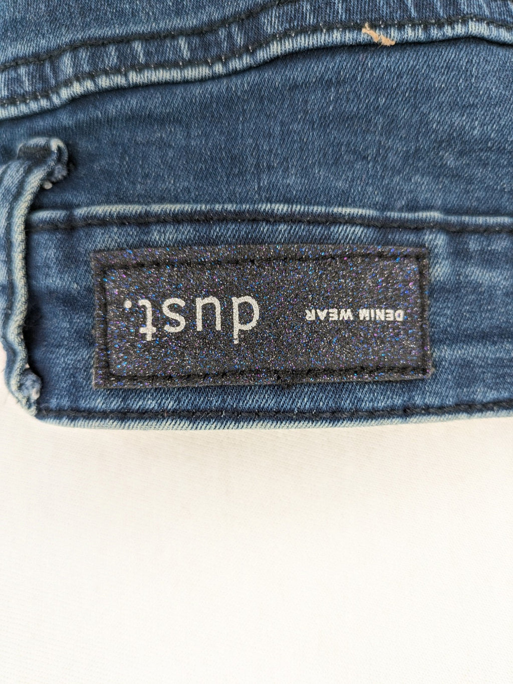 Dust blue skinny jeans with mid-rise waist and classic wash, stretch denim material.