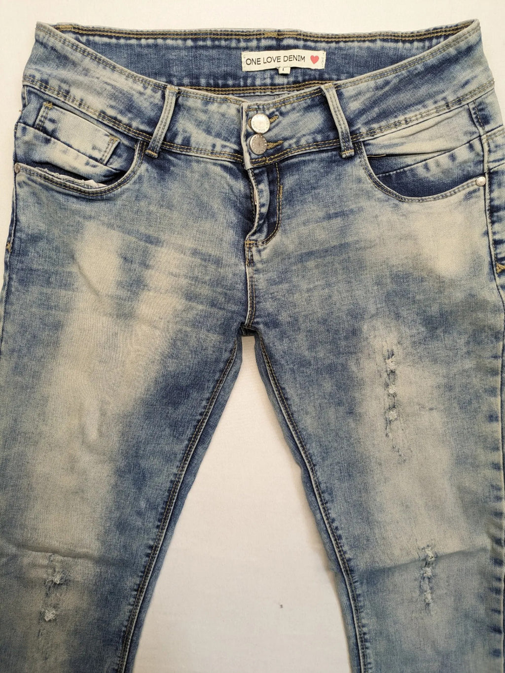 ONE LOVE DENIM blue straight jeans with distressed details and double button closure.