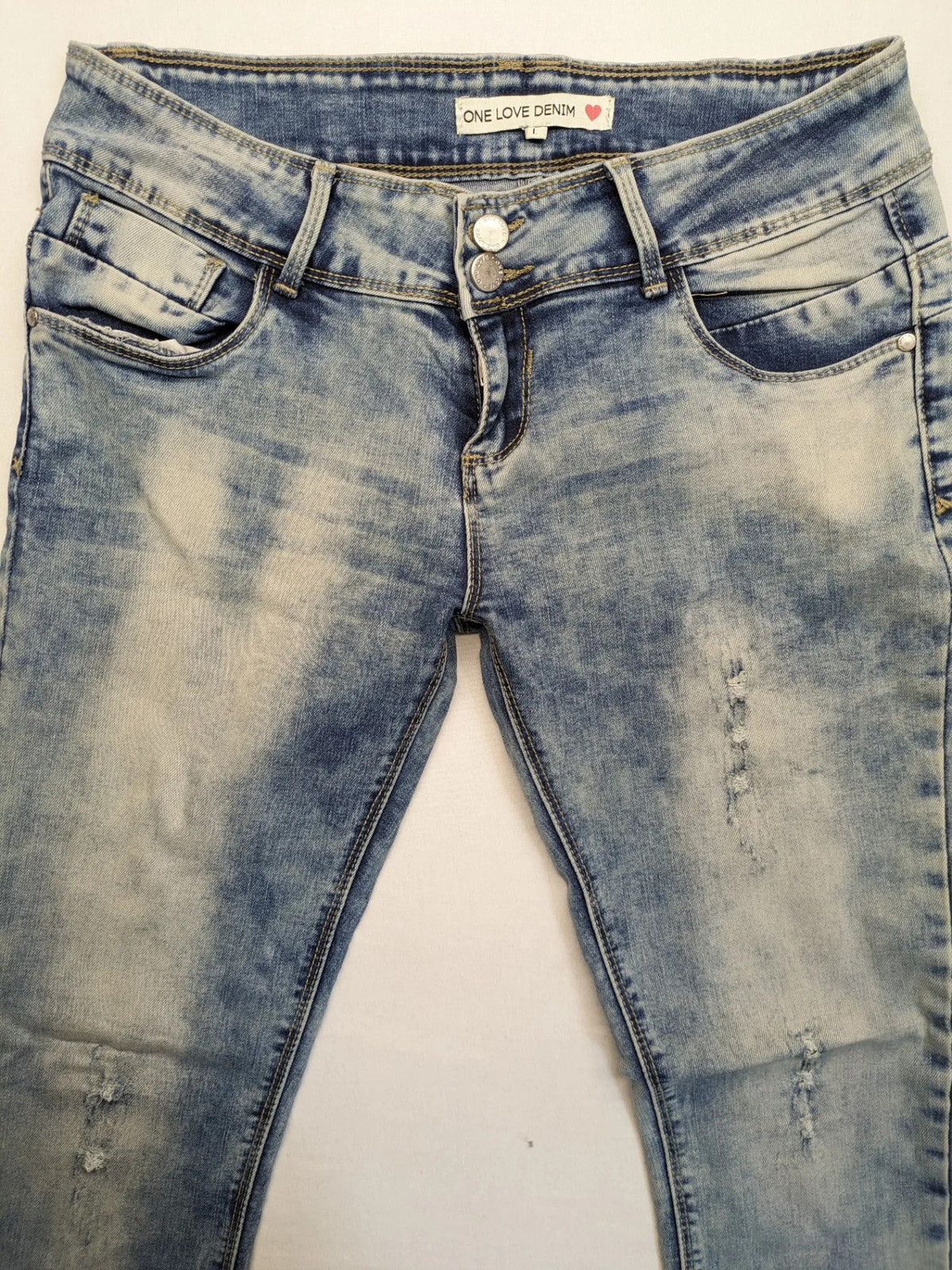 ONE LOVE DENIM blue straight jeans with distressed details and double button closure.