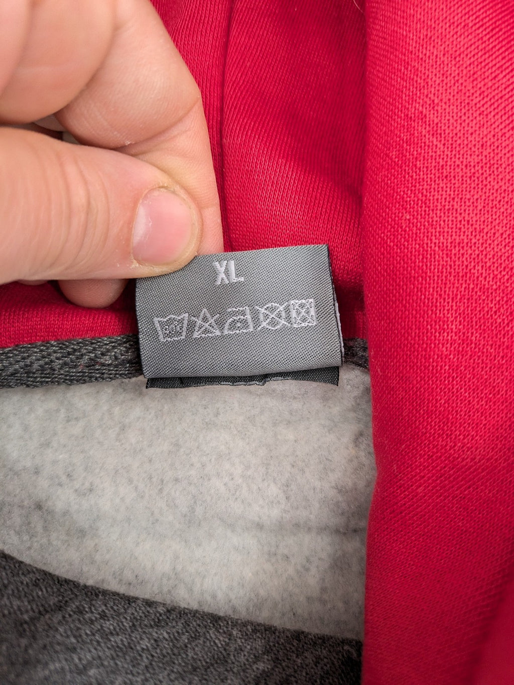 Bolf grey hoodie with pink contrast hood, kangaroo pocket, and ribbed cuffs.
