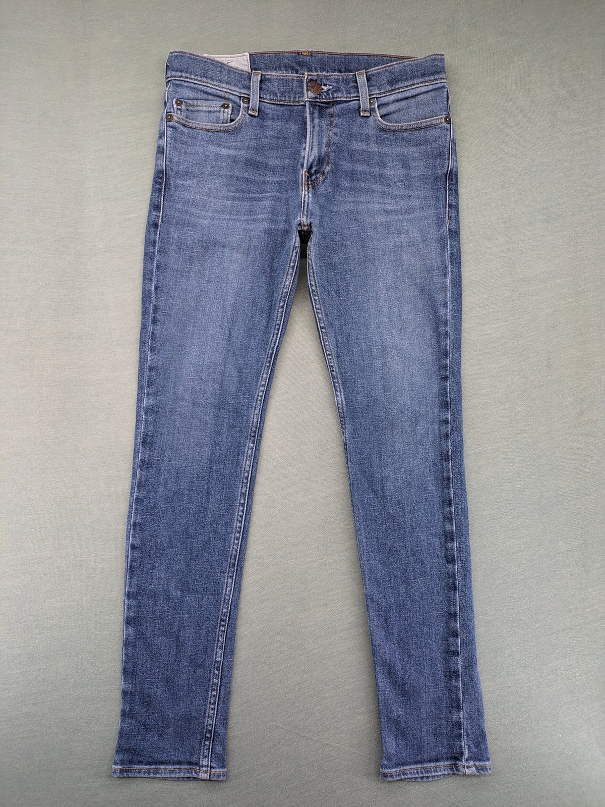 Hollister blue slim fit jeans with classic 5-pocket design and stretch denim material.