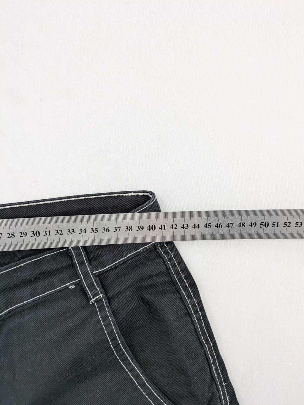 FSBN black baggy cargo pants with white contrast stitching and multiple pockets.