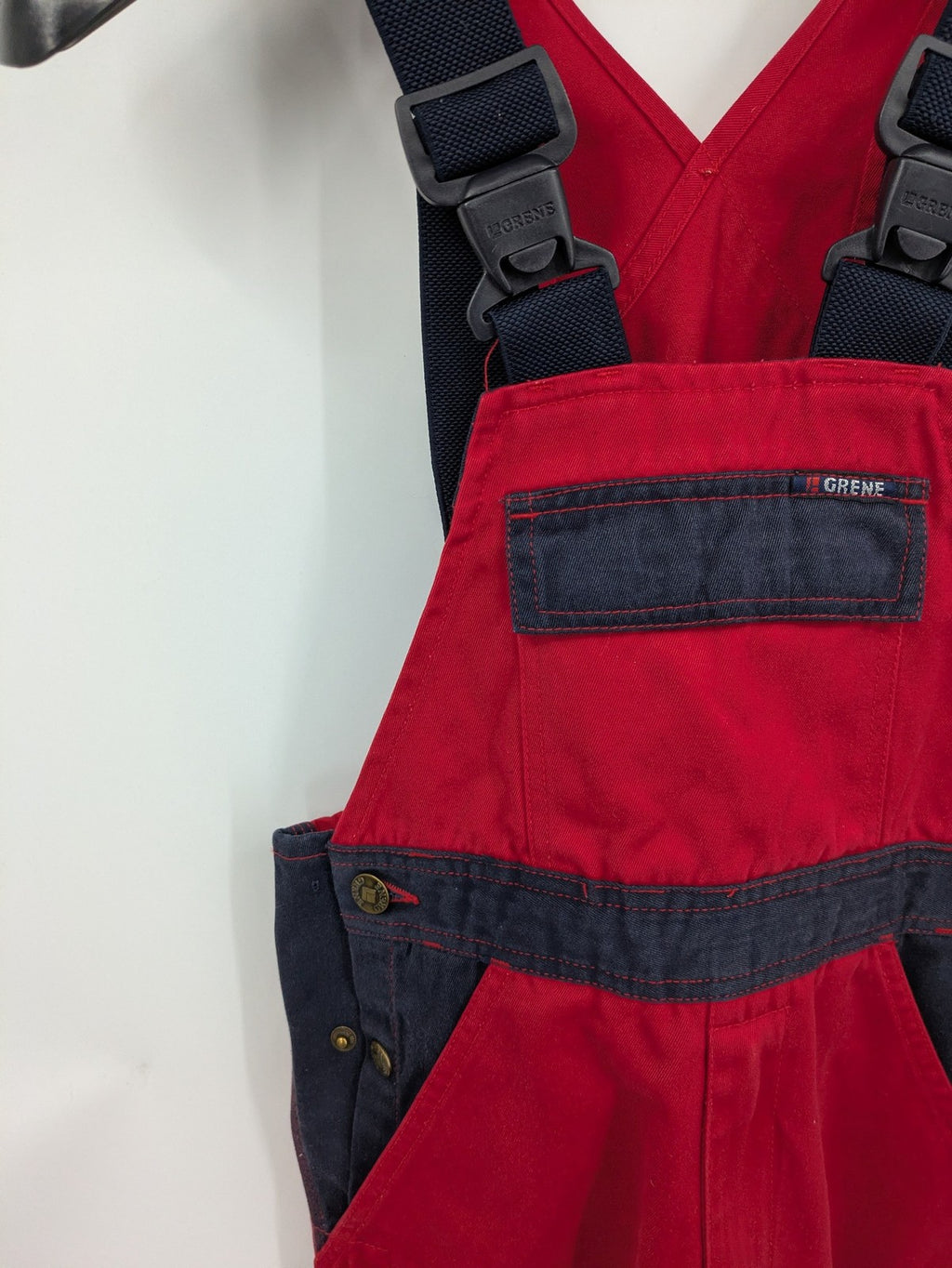 Grene navy red overall with adjustable straps, multiple pockets, and durable material.