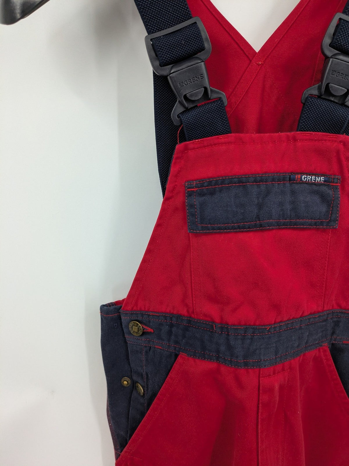 Grene navy red overall with adjustable straps, multiple pockets, and durable material.