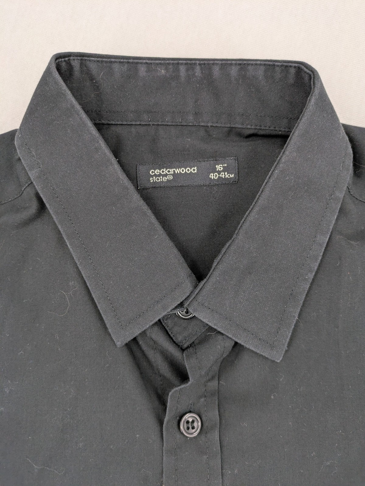 Cedarwood State black long sleeve shirt with classic collar and chest pocket.