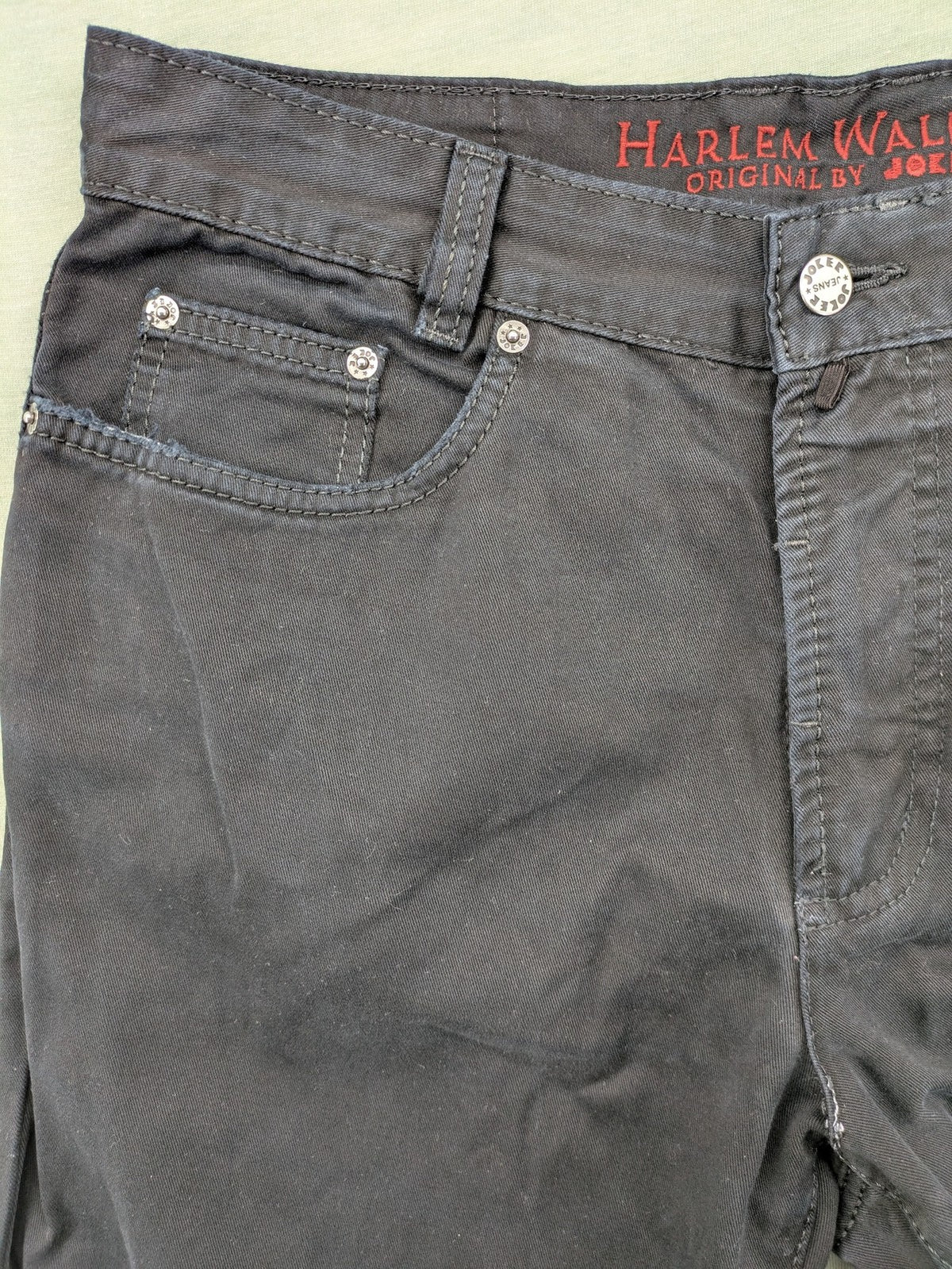 Joker black straight jeans five-pocket design with prominent stitching and brand details.