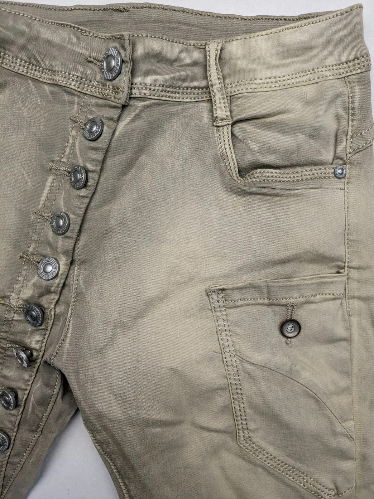 Mozaar beige straight jeans with unique asymmetrical button placket and practical pockets.