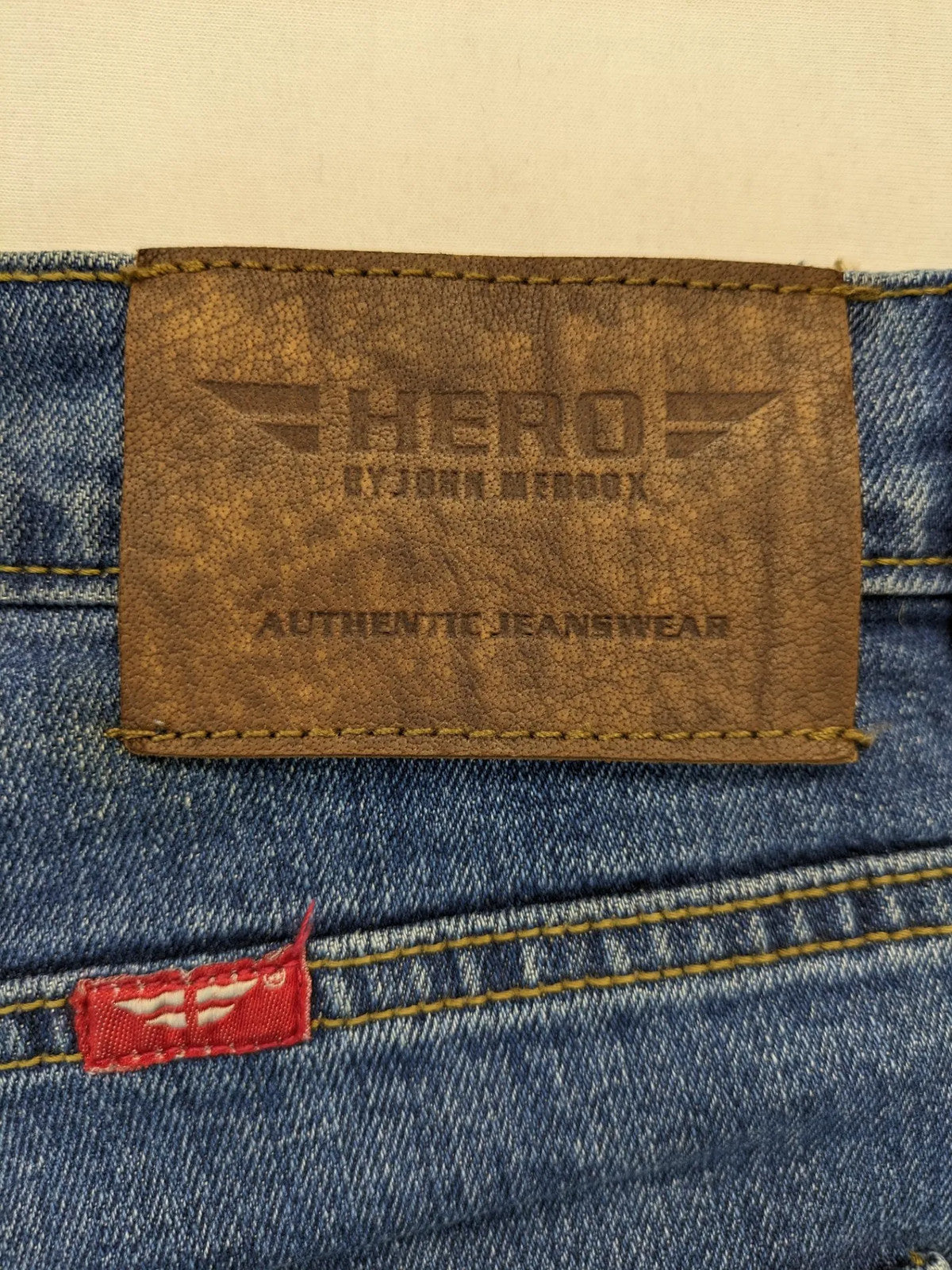 Hero By John Meddox blue straight jeans with five-pocket design and zip fly.