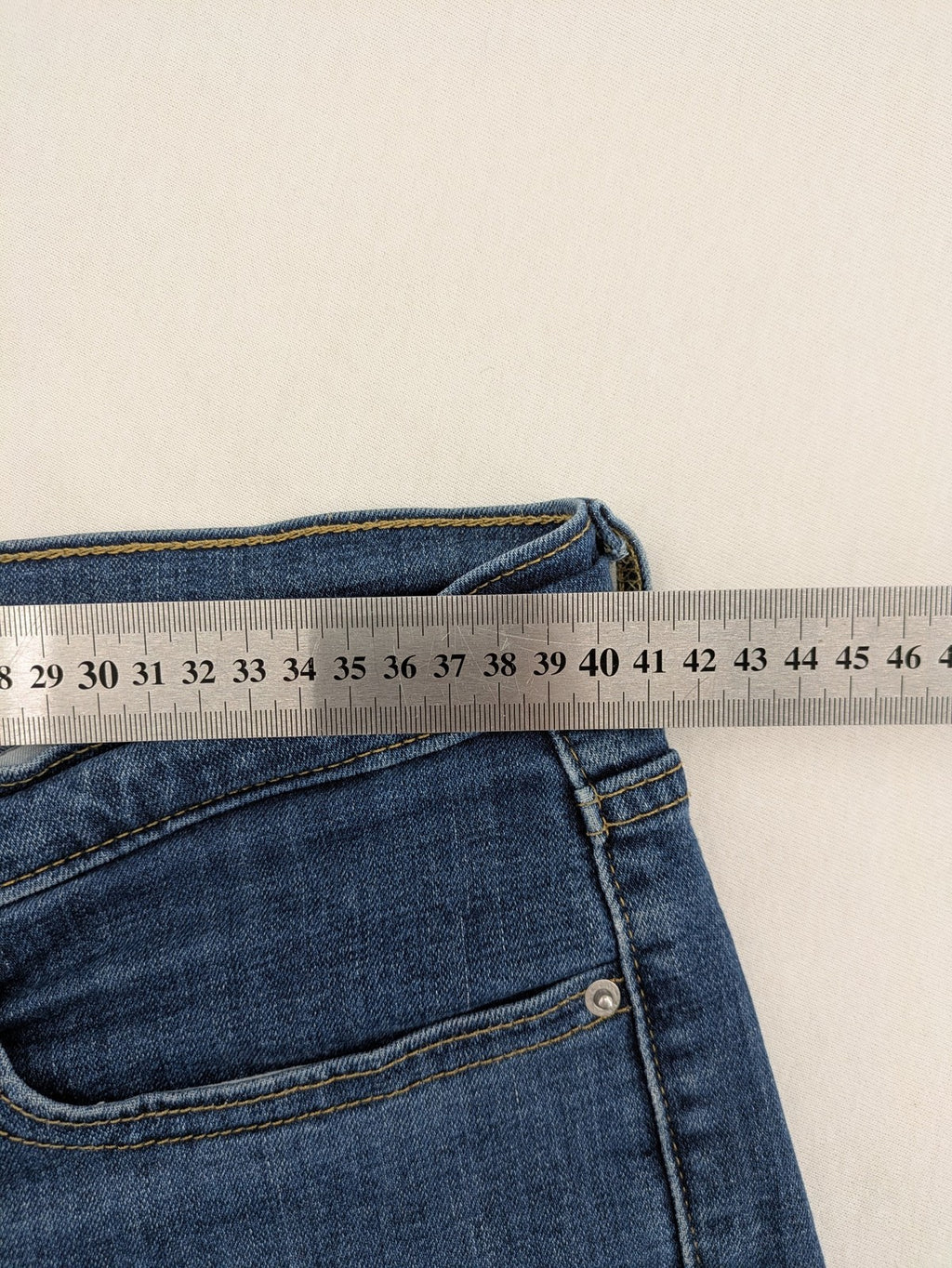Levi's blue denim Bermuda shorts with rolled cuffs and classic 5-pocket design.
