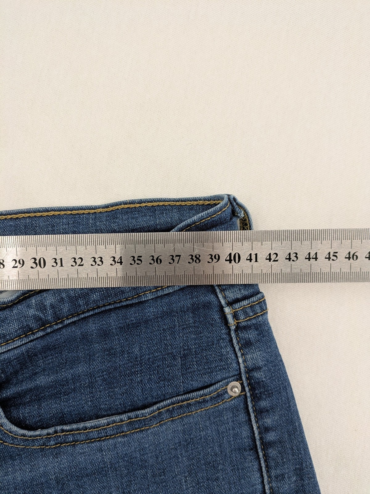 Levi's blue denim Bermuda shorts with rolled cuffs and classic 5-pocket design.