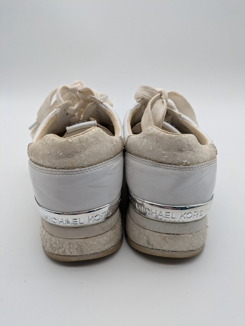 Michael Kors multi sneaker white leather and cream textile with silver logo details.