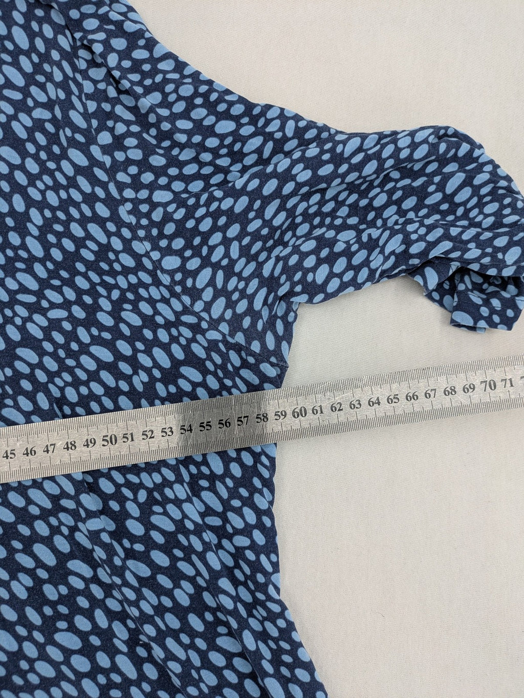 Ulla Popken blue tunic top with light blue polka dots and A-line cut.