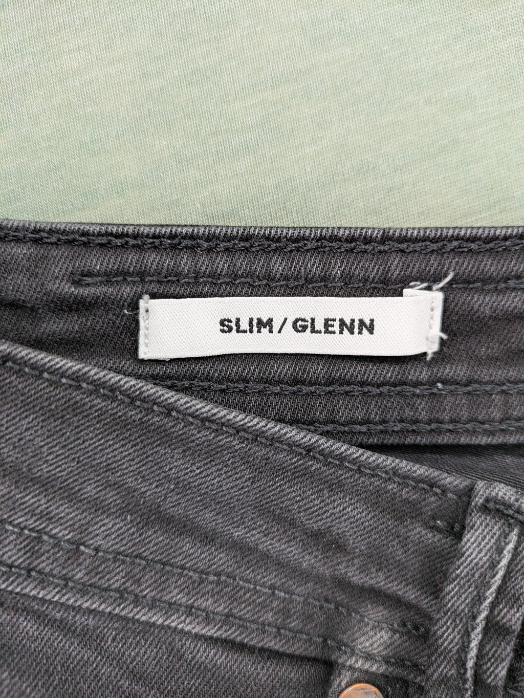 Jack & Jones black slim fit jeans faded wash stretch denim with logo detail.