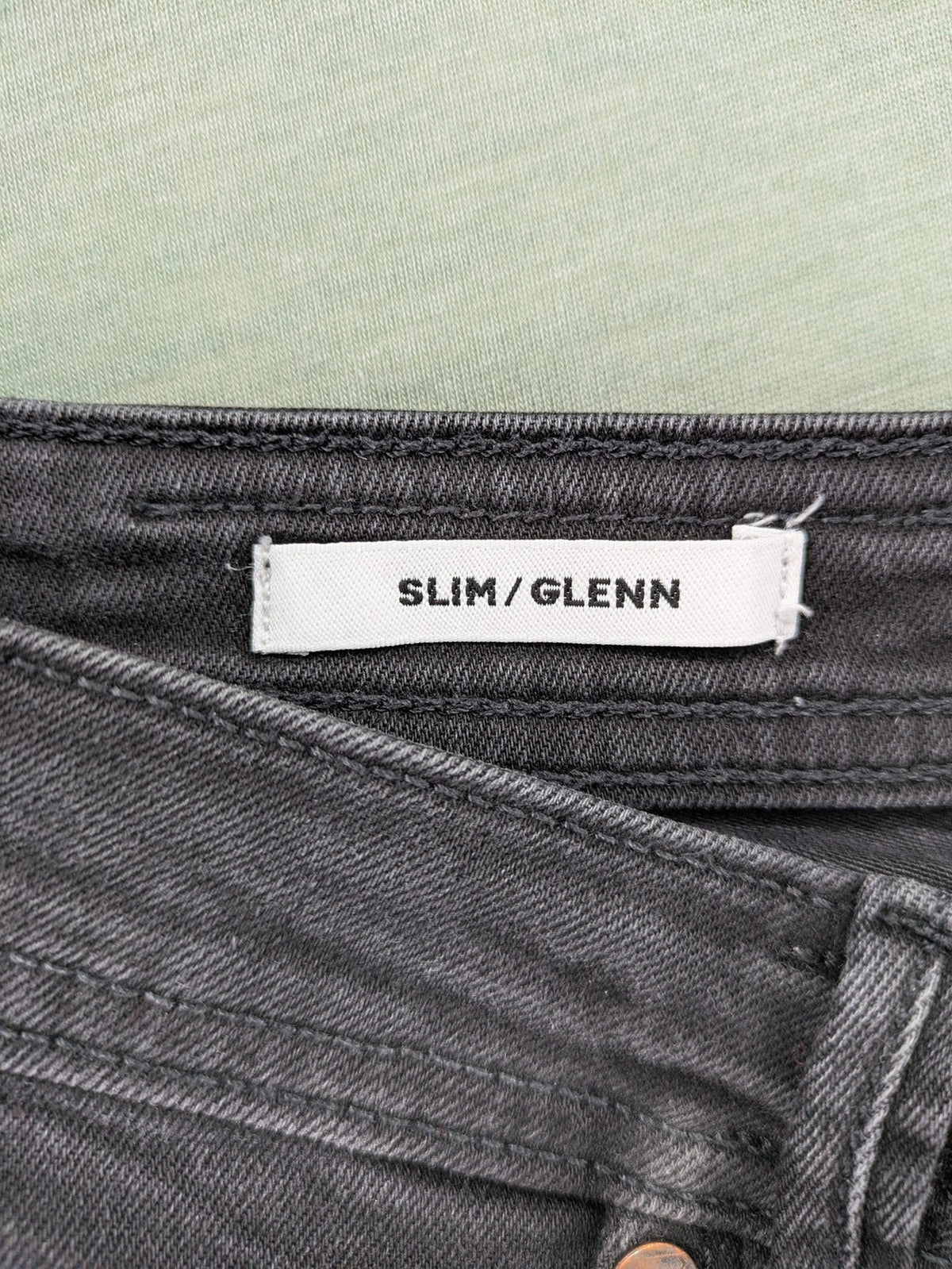 Jack & Jones black slim fit jeans faded wash stretch denim with logo detail.