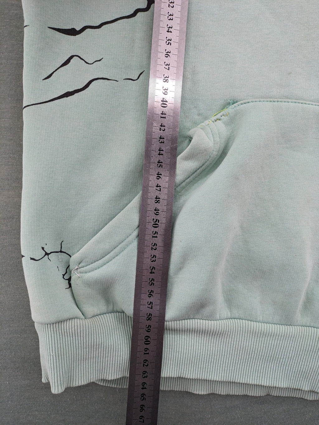Tupac black and green zip-through hoodie with "Only God Can Judge Me" front print and angel wings graphic.