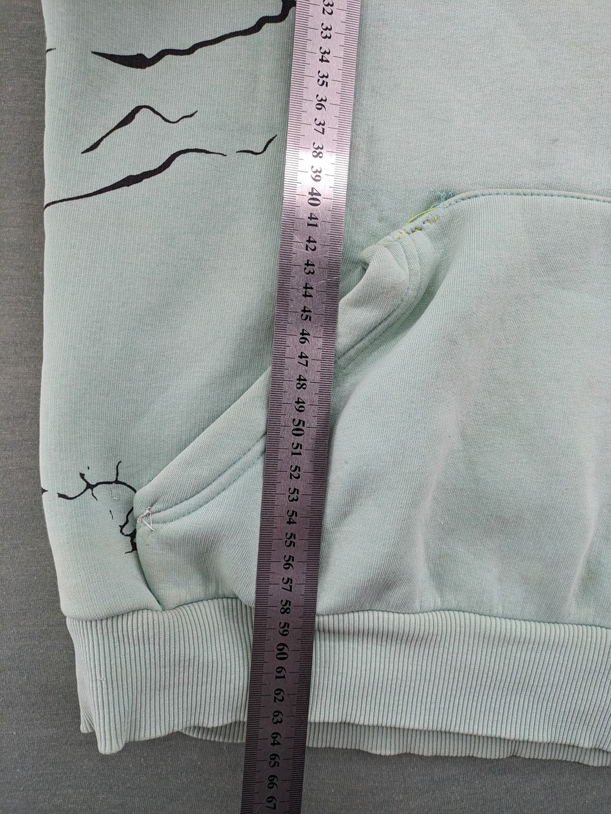 Tupac black and green zip-through hoodie with "Only God Can Judge Me" front print and angel wings graphic.