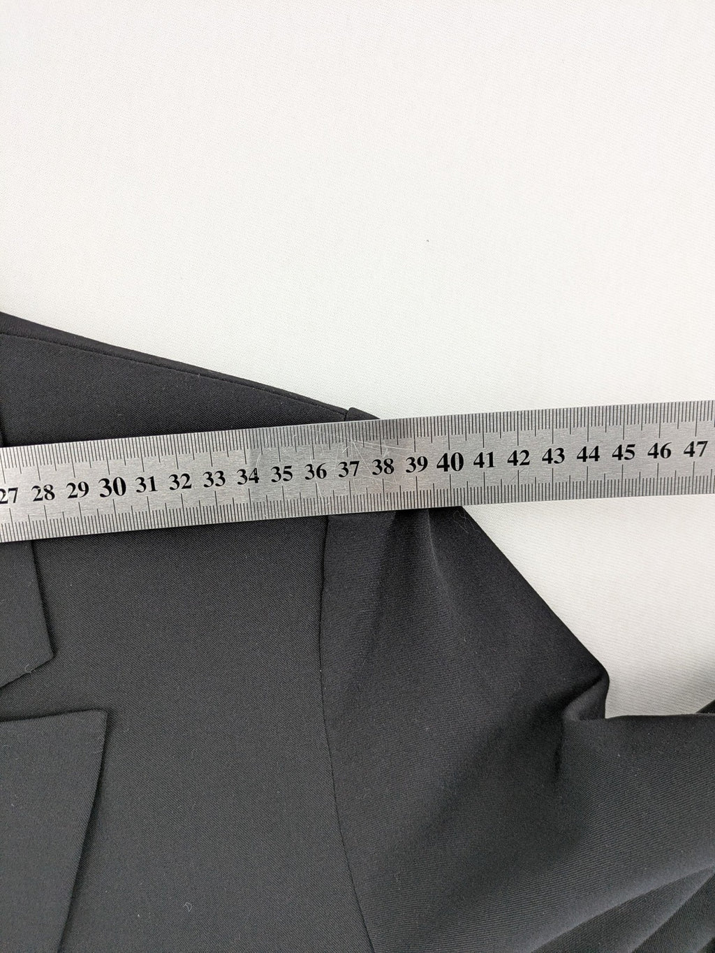 Lindex black blazer coat two-button design with subtle embroidery and tailored silhouette.