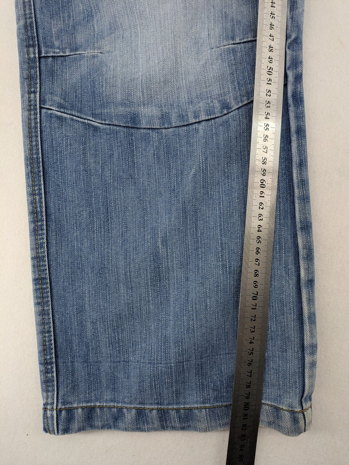 Premium Denim blue straight leg jeans with biker knee inserts and five-pocket design.