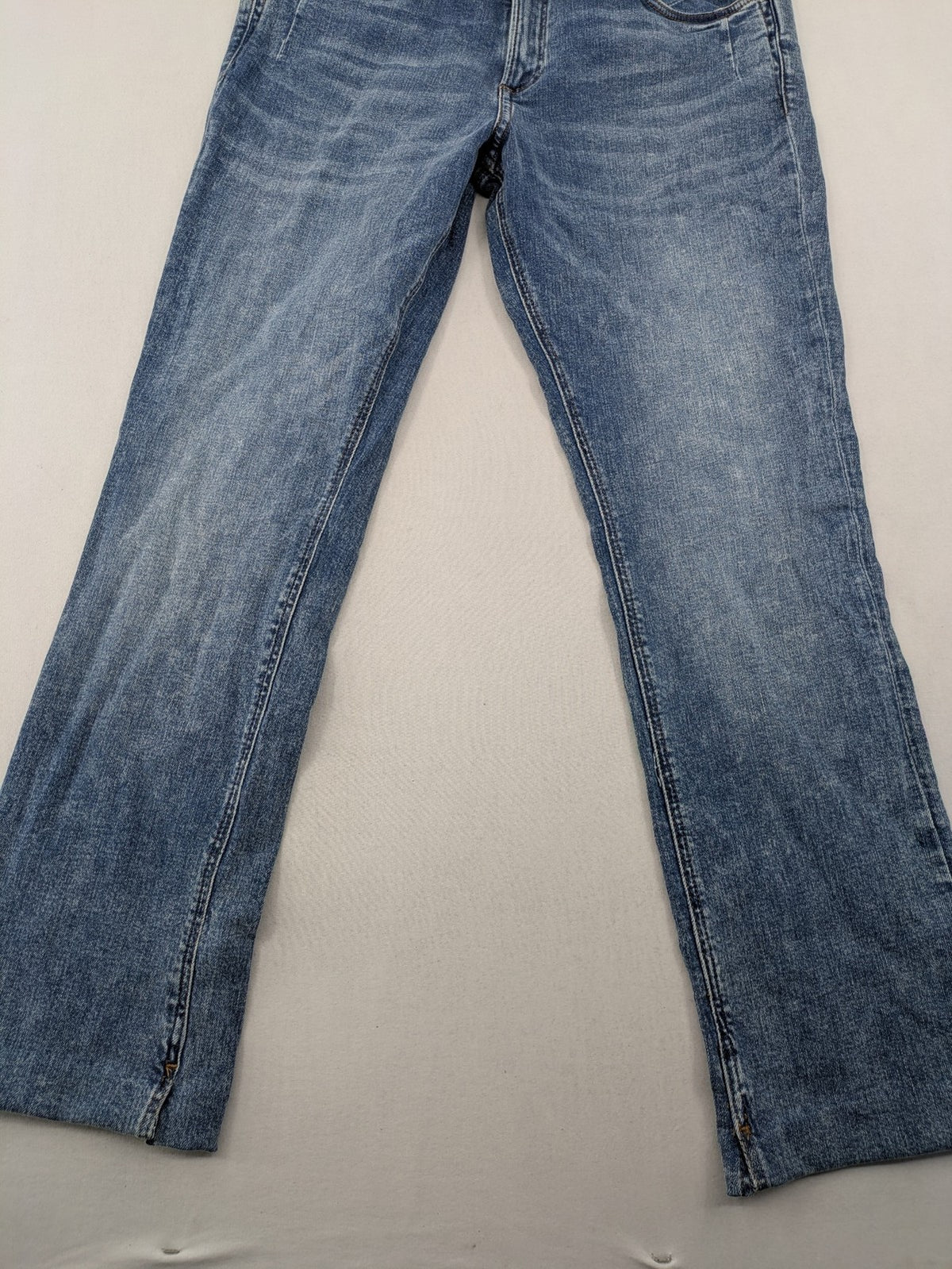 QS by s.Oliver green bootcut jeans with ankle zippers and classic denim wash.