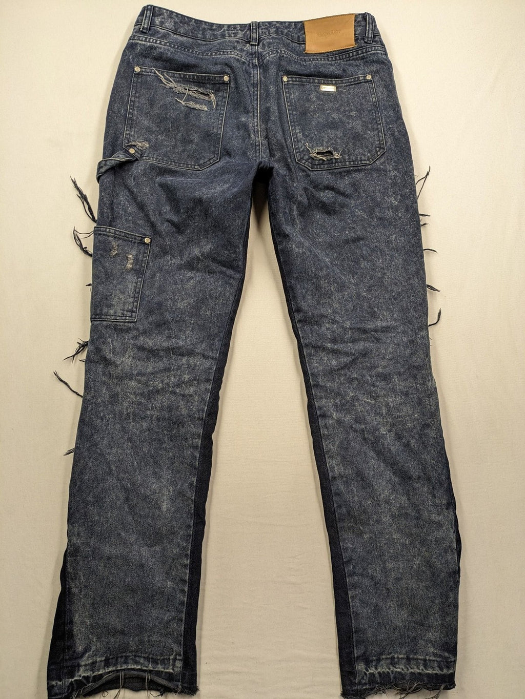 Reternity straight jeans blue black patchwork design with distressed details and frayed seams.
