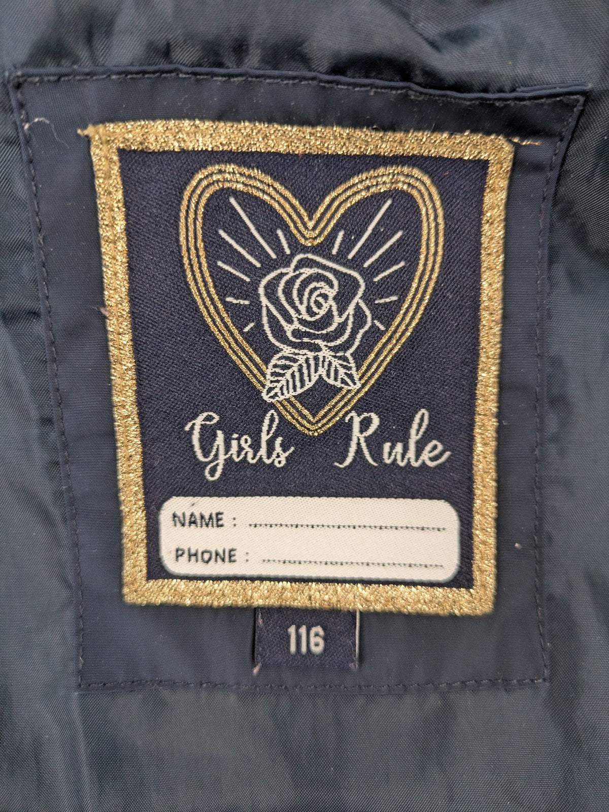GEF cream coat with quilted design, fleece-lined hood, and faux fur trim.