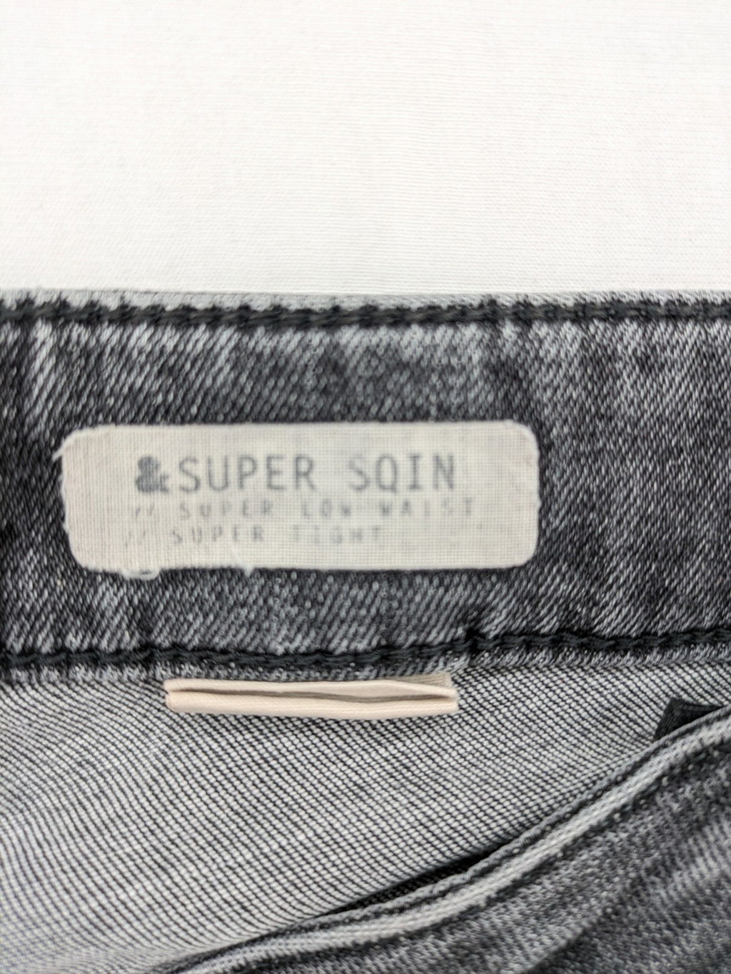 H&M grey skinny jeans with low rise, classic 5-pocket style, and washed denim finish.