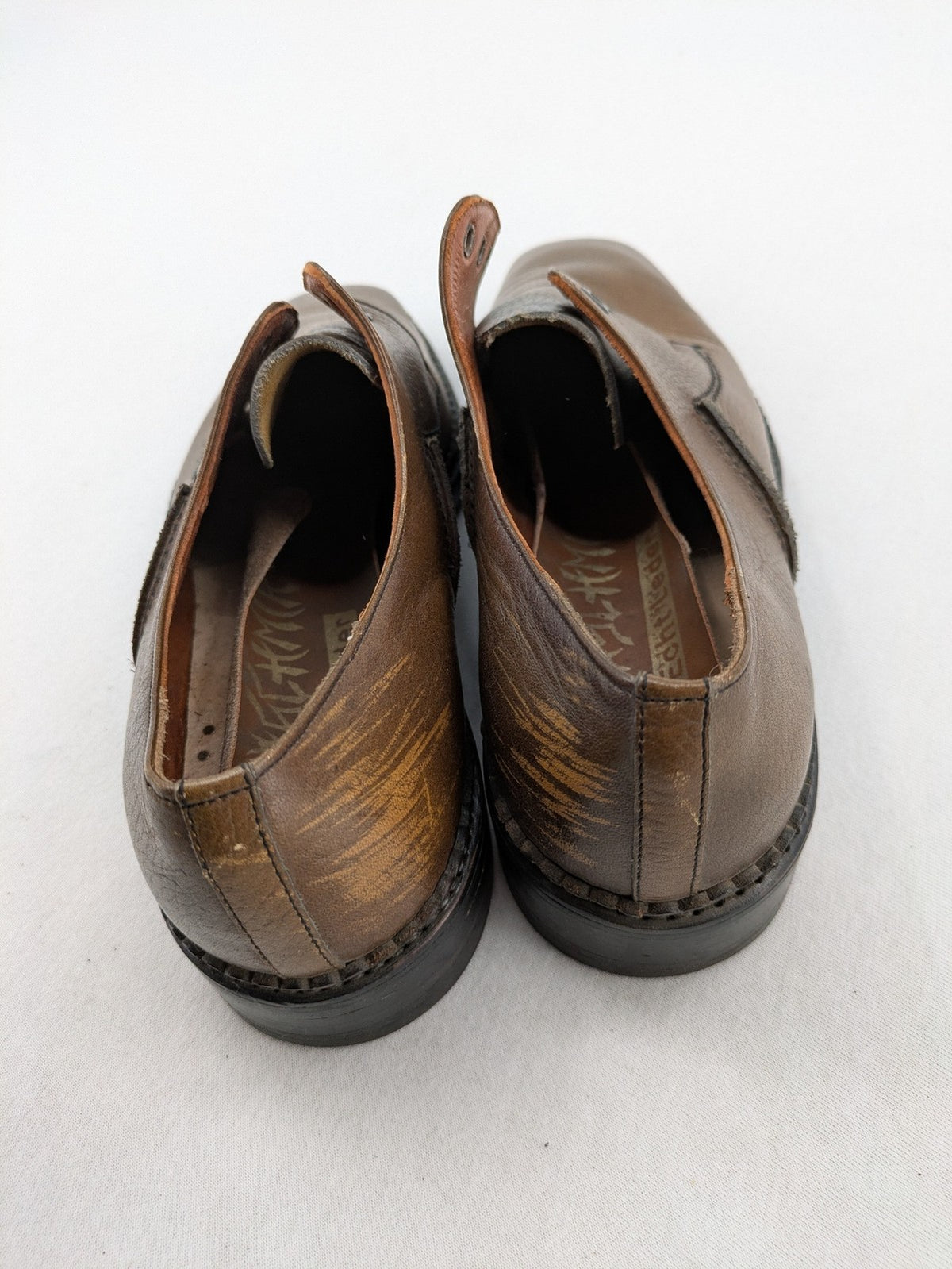 Fonda brown deck shoes genuine leather square toe design with decorative stitching.