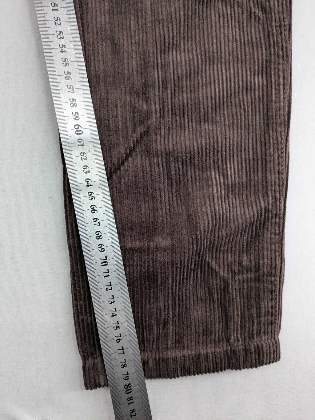 Alma & Lovis brown cord pants with elastic waistband, drawstring, and front patch pockets.