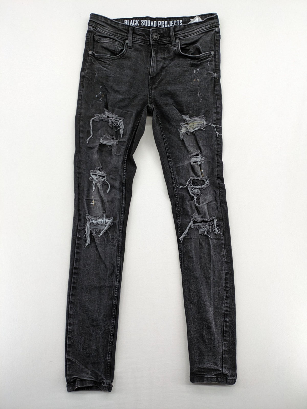 Black Squad skinny fit jeans black distressed ripped design with subtle paint splatter.