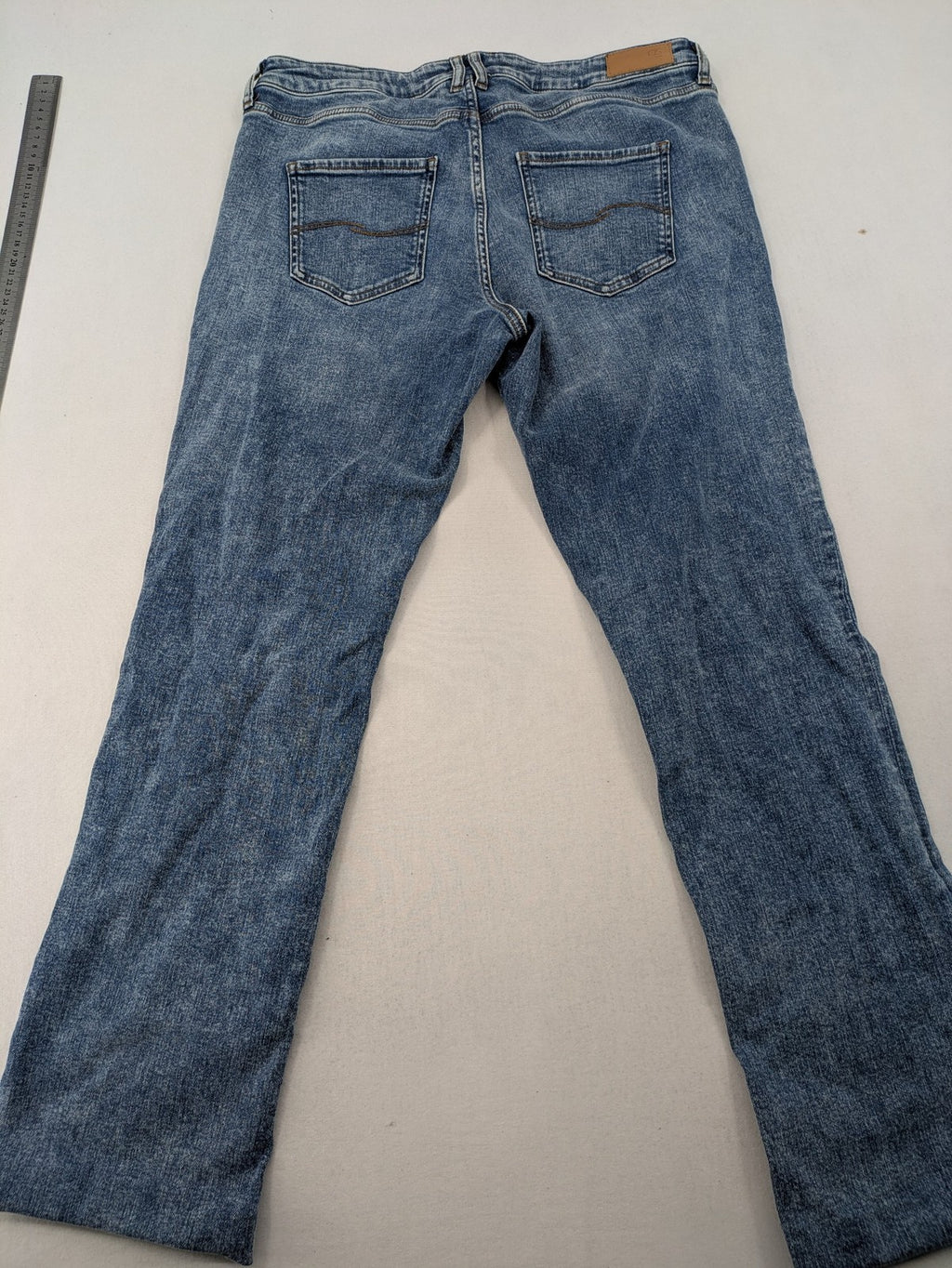 QS by s.Oliver green bootcut jeans with ankle zippers and classic denim wash.