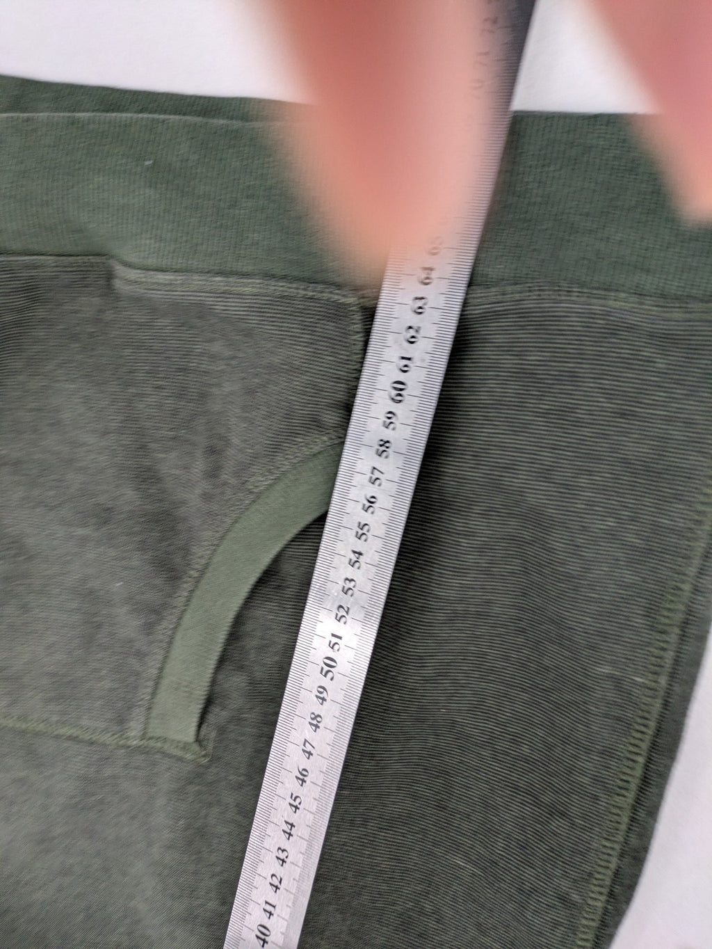 Roadsign Australia green hoodie with mountain graphic print and logo patch on sleeve.