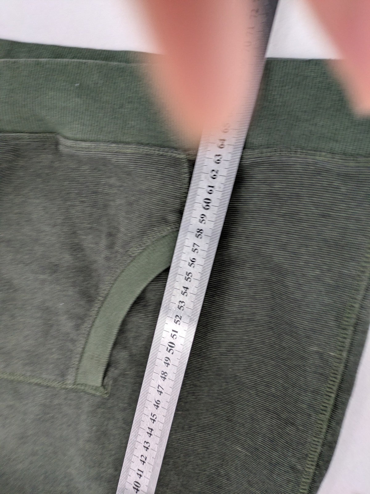 Roadsign Australia green hoodie with mountain graphic print and logo patch on sleeve.