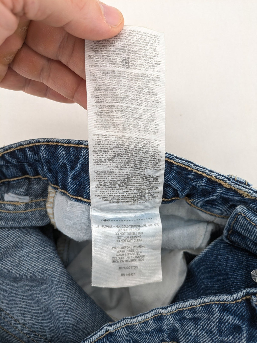 FSBN blue straight jeans with distressed knee rips and classic button fly.