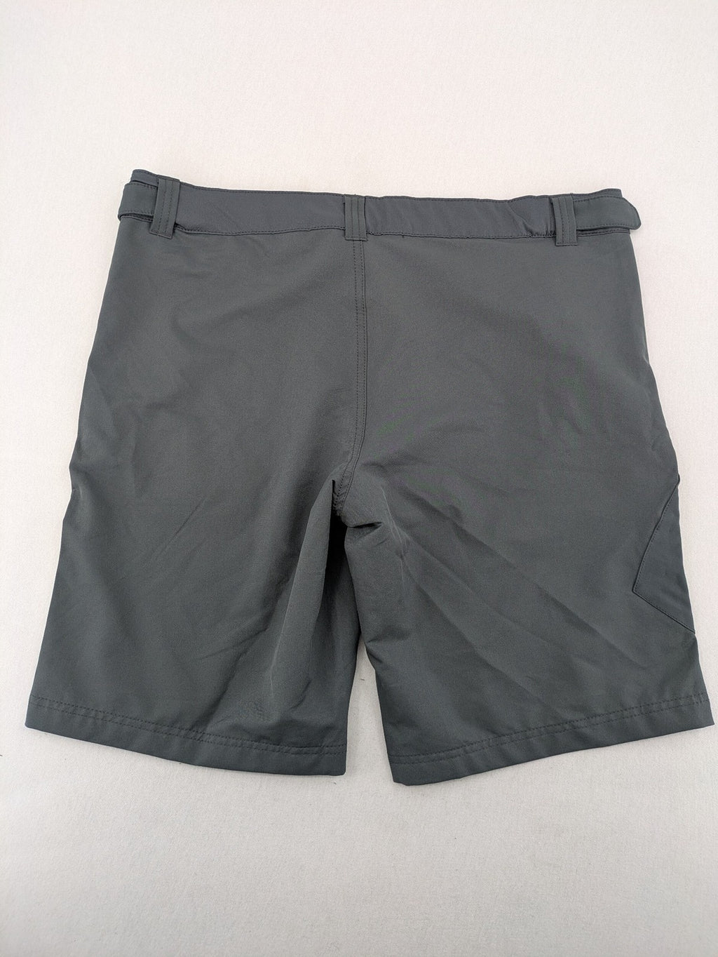 Outdoor grey functional shorts with adjustable velcro waistband and zippered leg pocket.