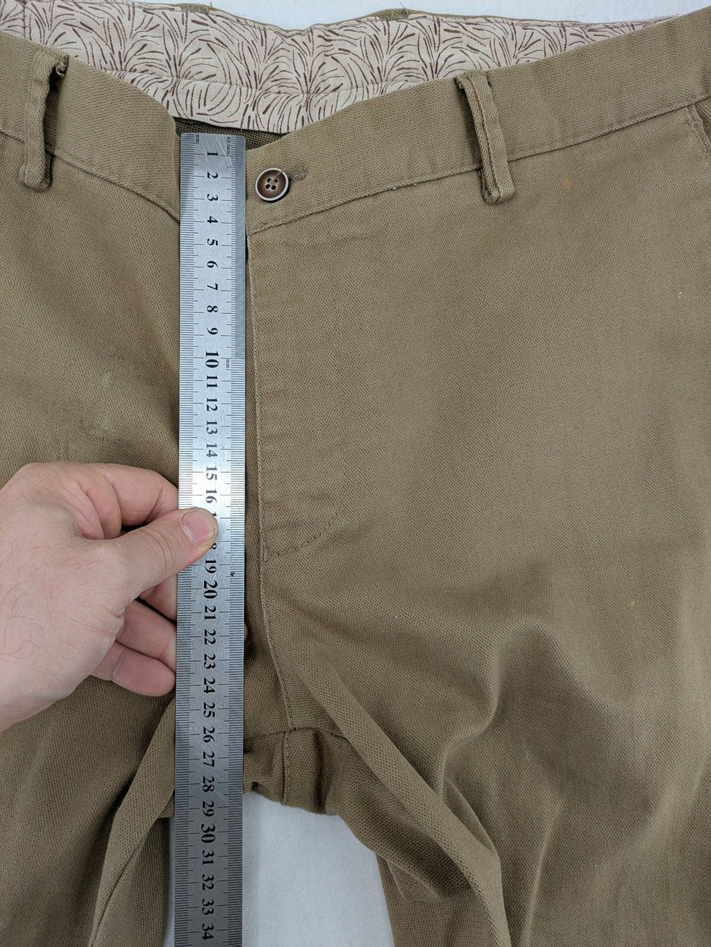 Süvari khaki chino pants flat-front design with patterned waistband detail, cotton blend material.
