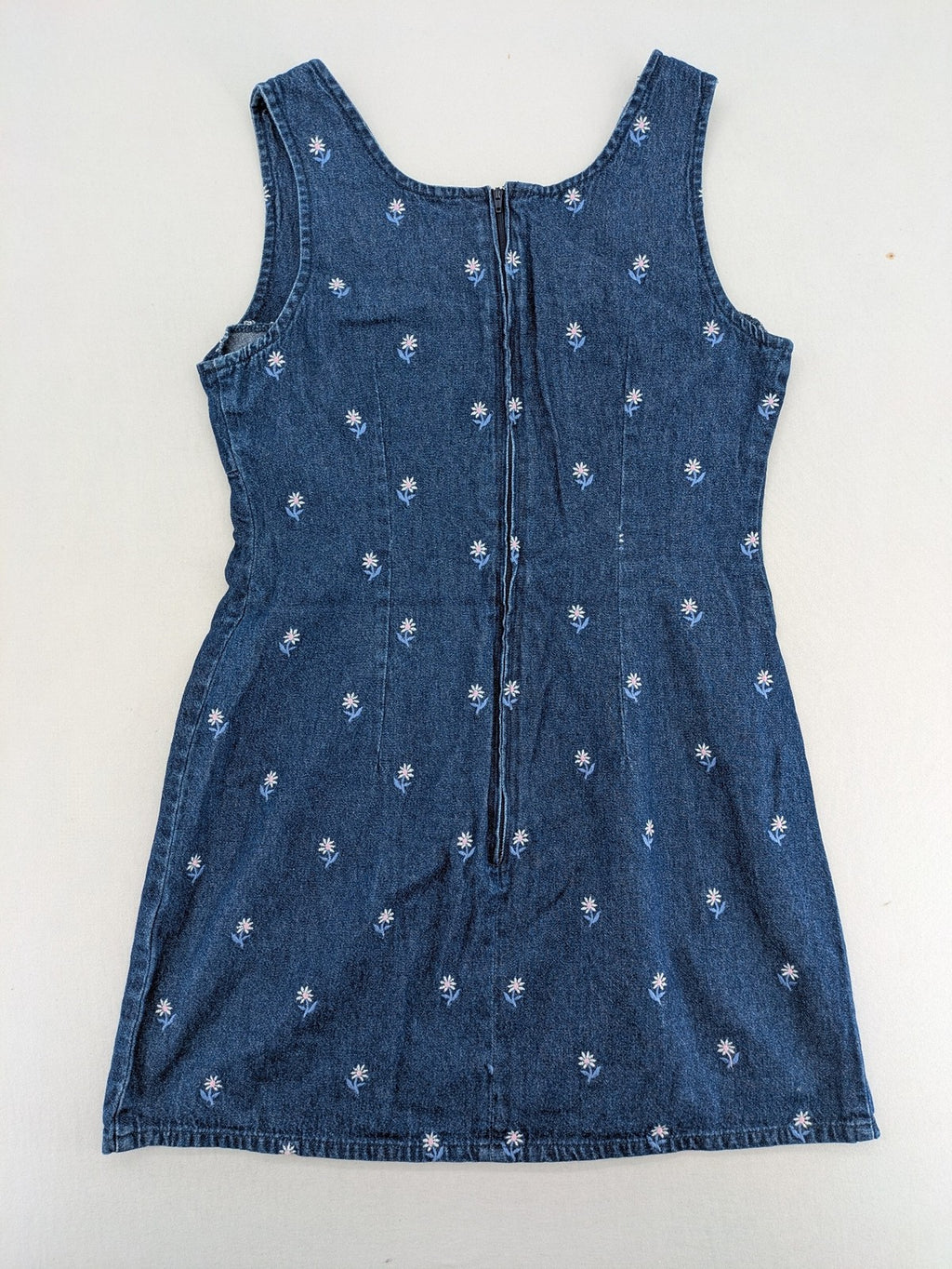 Damen blue denim mini dress with all-over white and light blue floral embroidery.