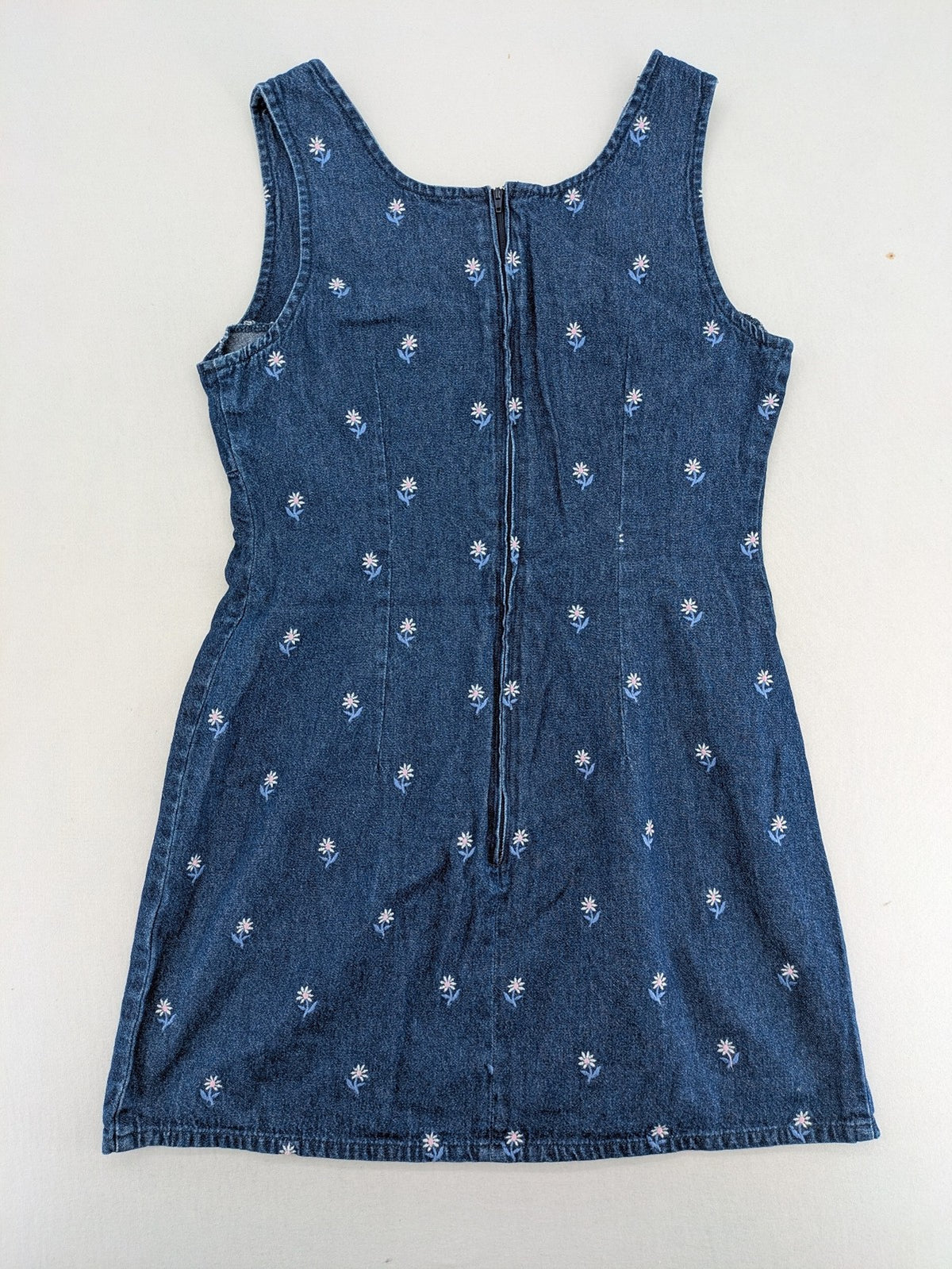 Damen blue denim mini dress with all-over white and light blue floral embroidery.