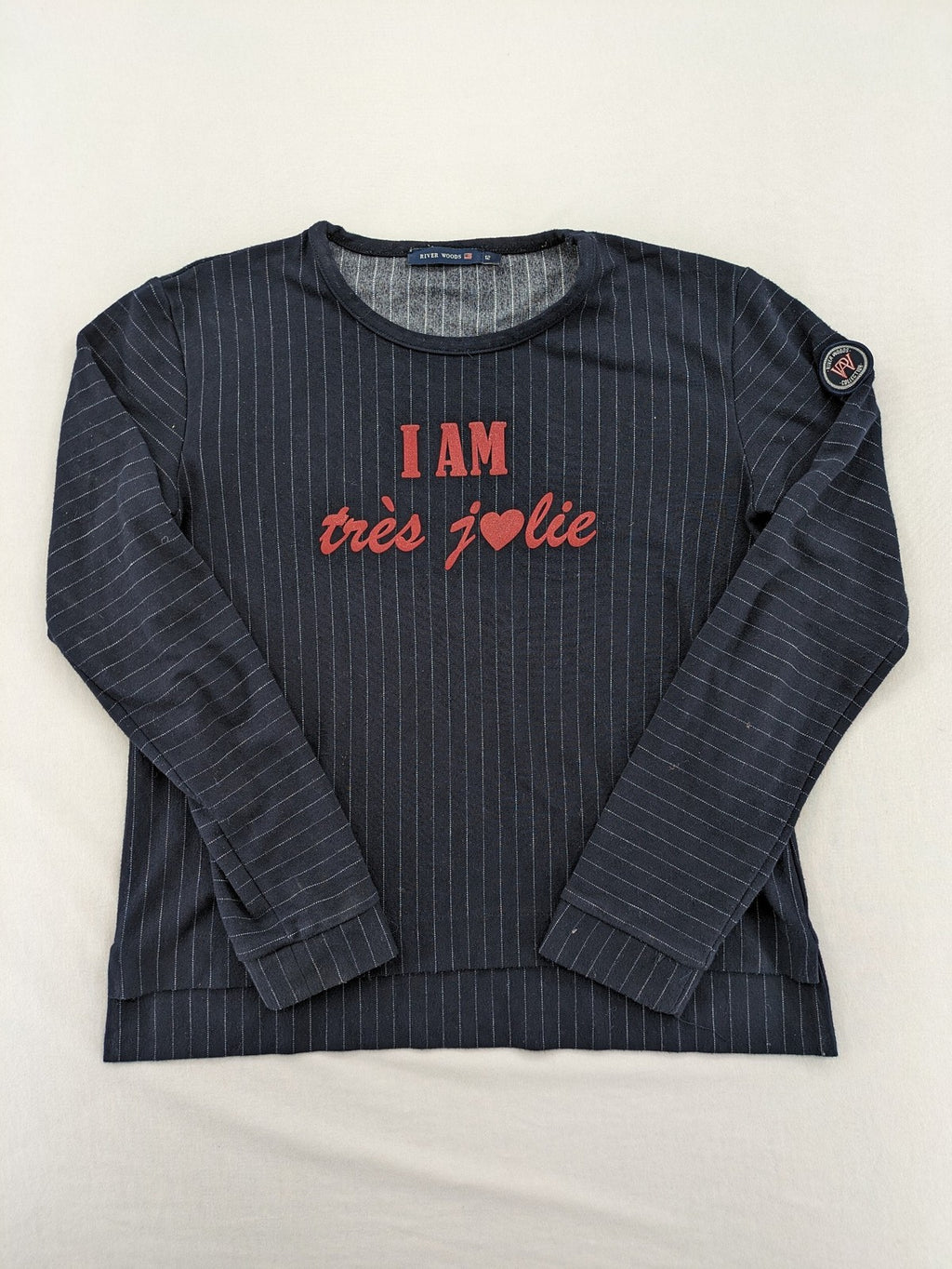 RIVER WOODS navy long sleeve top with white pinstripes and red "I AM très jolie" slogan.