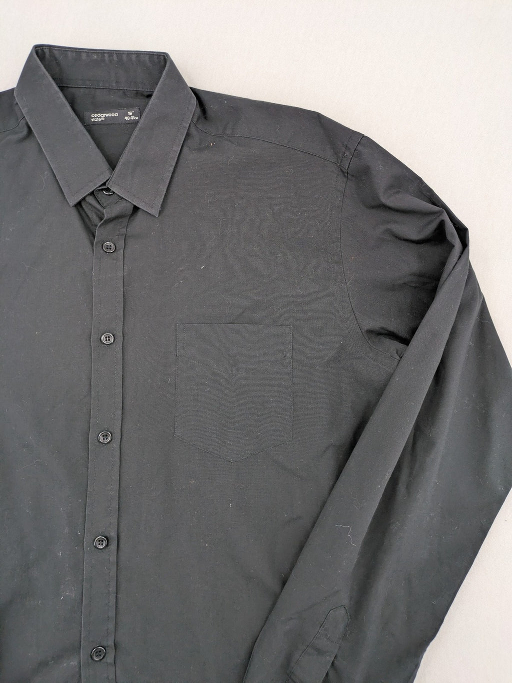 Cedarwood State black long sleeve shirt with classic collar and chest pocket.