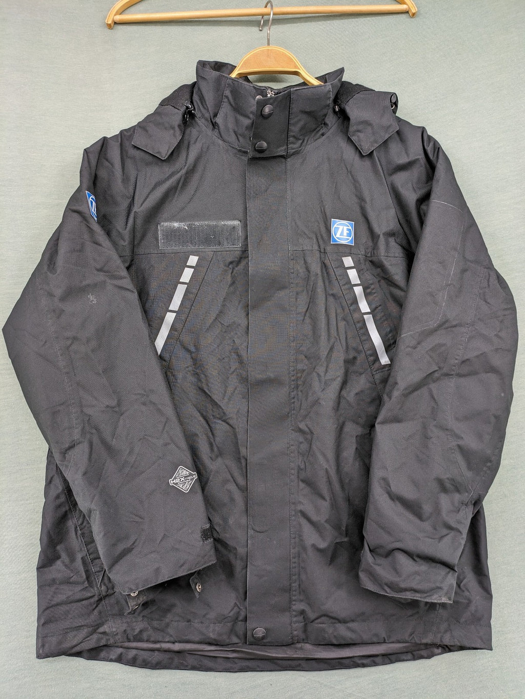 Stormtech black waterproof jacket with ZF logo, H2Xtreme technology, front zipper, and hood.
