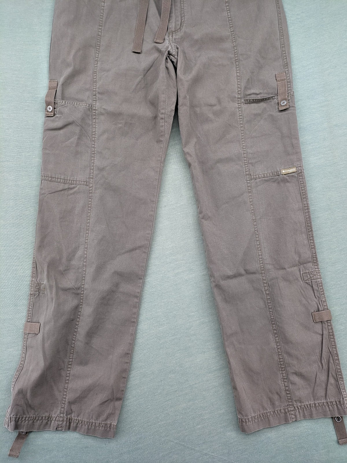 Columbia grey cargo pants with multiple pockets and drawstring waist, 100% cotton.