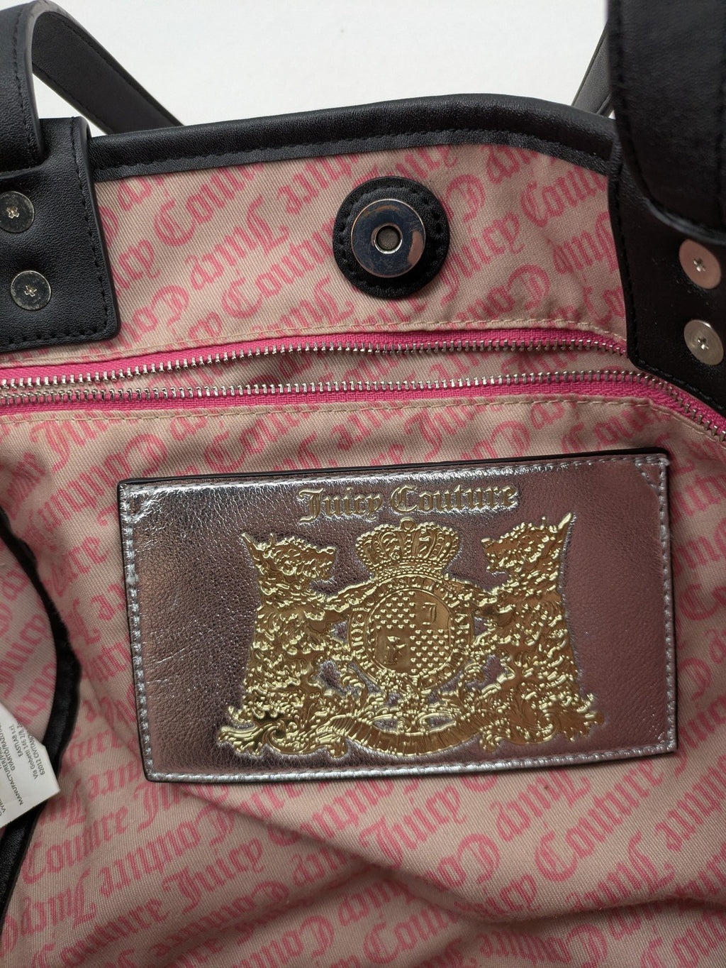 Juicy Couture pink velour handbag with oversized black logo and faux leather straps.