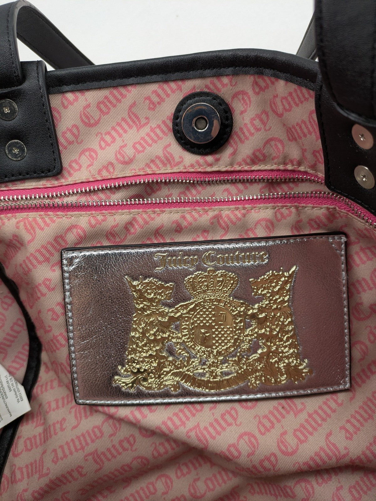 Juicy Couture pink velour handbag with oversized black logo and faux leather straps.