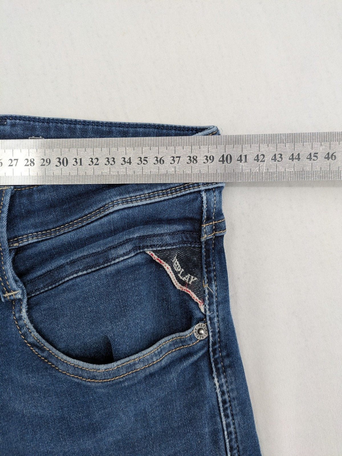 Replay slim fit jeans blue with subtle fading and stretch denim material.